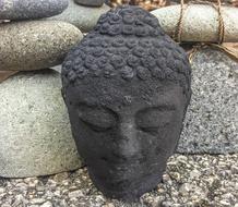 stone head of a Buddha on a background of a pyramid of stones
