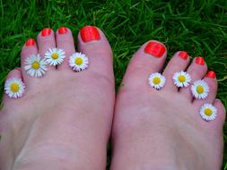 toes with bright orange nail varnish