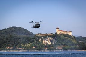 Rescue Helicopter in flight above scenic coastline