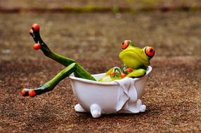ceramic green Frog in a white bath