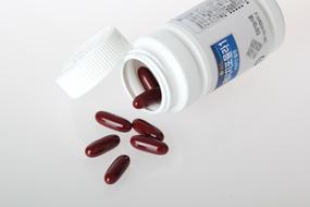 pour vitamin capsules out of the bottle