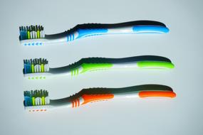 Tooth Brushes Clean blue green orange