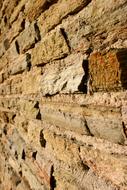 Close-up of the colorful texture of the brick wall, of the architecture, in France