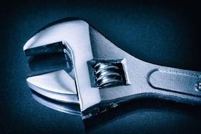 shiny wrench on dark background