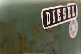 White and black "DIESEL" sign on the old, retro, green tractor