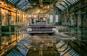 retro car in a hangar in an abandoned factory