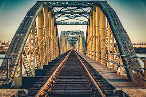 interior of Railroad Bridge above water at Sunset