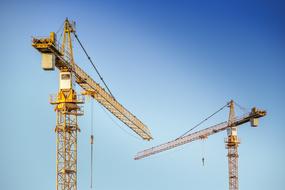 two tower cranes at sky