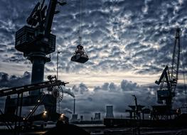 black and white photo of a port crane on the bank of the Rhine