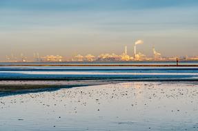 photo of a beach in Liman Bay against the background of an industrial plant