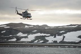 rescue helicopter flying over the mountain