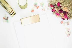 flowers and paper binders on White Desk