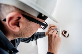 electrician fixing an outlet