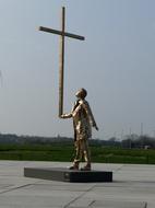 sculpture of a man holding a cross, jan fabre