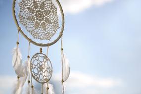 white dream catcher with feathers