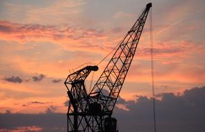 boom of Harbour Crane at Sunset Sky