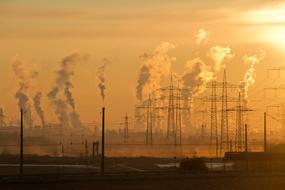 industrial plants and power towers at sunset