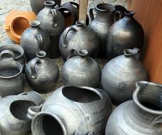 Beautiful, gray, shiny pots near the wall