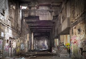 dirty walls with graffiti in an abandoned factory