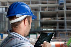 engineer in blue helmet with tablet