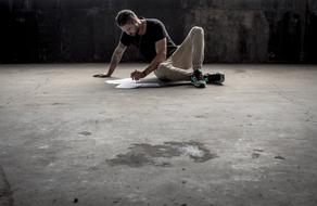 man working with documents on the floor