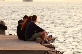 group of young people resting on waterside