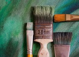 four brushes at green background