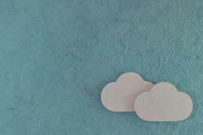 two paper clouds on a blue background