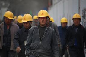 group of asian Industrial Workers in helmets