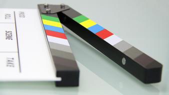 Colorful clapper board with black and white text for cinematography on the glass surface