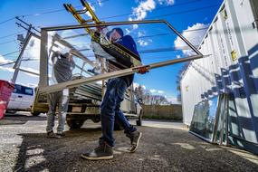 workers carrying glass