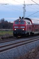 red passenger train on rails