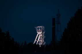 illuminated Headframe of Mining Tower at night sky
