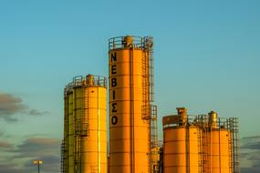 yellow Industrial tanks at evening sky