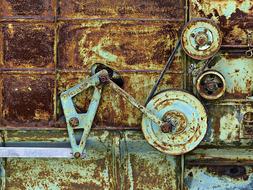 Close-up of the colorful, rusty, metal old machine, with the details