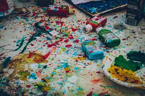 tubes of paint and colorful stains on the table