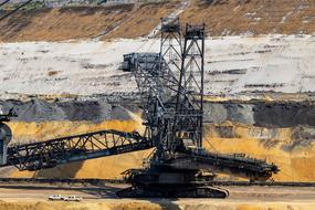 Machine for the open pit mining, on the colorful landscape