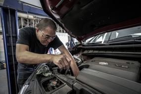 Auto Repair, mature asian man Changing Oil