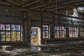 Inside of the abandoned, wet building with colorful graffities