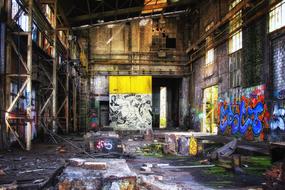 Old, abandoned building, with the colorful graffities, in lights and shadows
