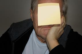 blank sheet of paper on old man face