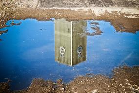 reflection of Factory building on puddle