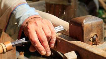 hands of woodworking master close up