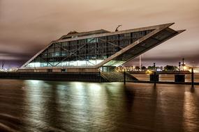 Beautiful Dockland, with the colorful lights, in Hamburg, Germany, with the reflections in the Elbe River, in the evening