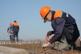 workers in orange helmets at a construction site