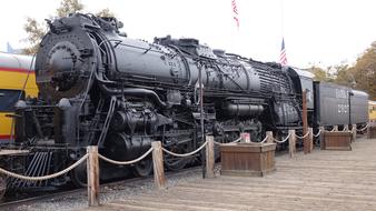 Beautiful, old, black train with the flag of USA