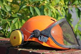 orange garden helmet on blurred background