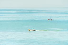 two fishing boats on the coastline