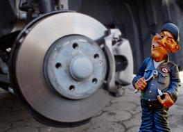 car mechanic figurine near the brake system
