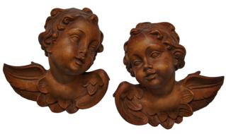 two carved wooden angels on white